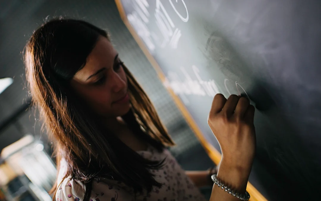 A team member writes notes during a video pre-production planning session, illustrating collaboration and the early steps of how to plan a video shoot.