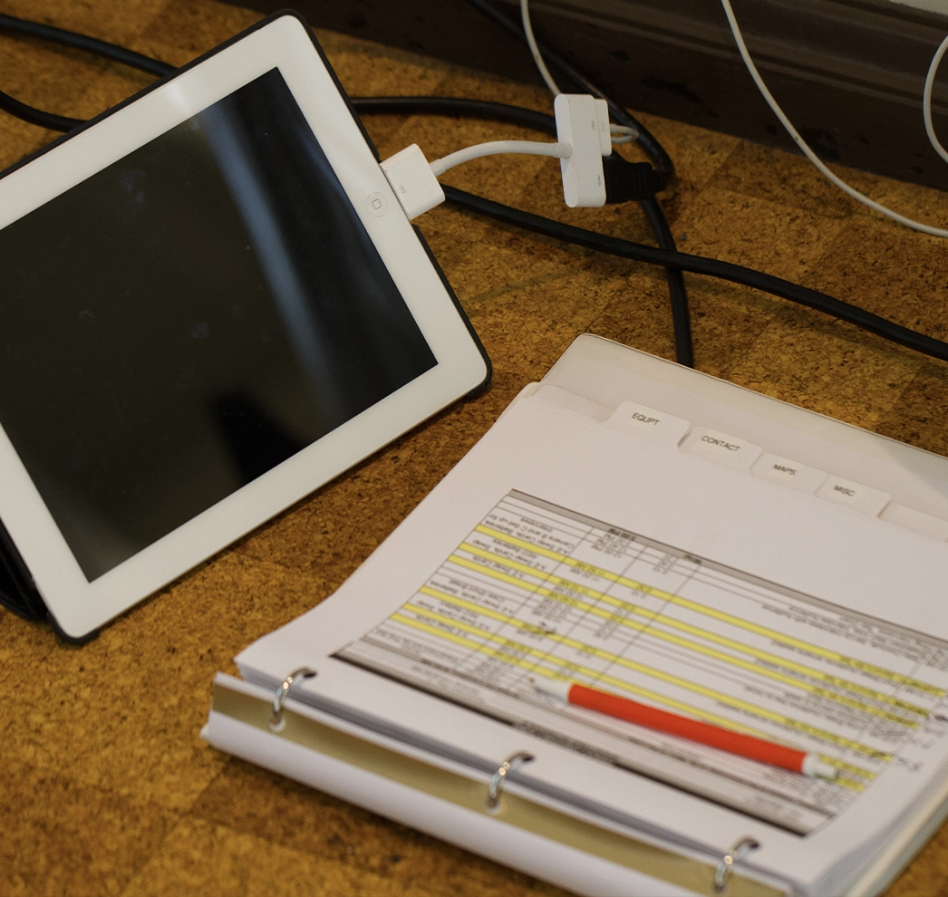 A tablet and a clipboard displaying a pre-production checklist, showcasing the essential tools and steps used in how to plan a video shoot.