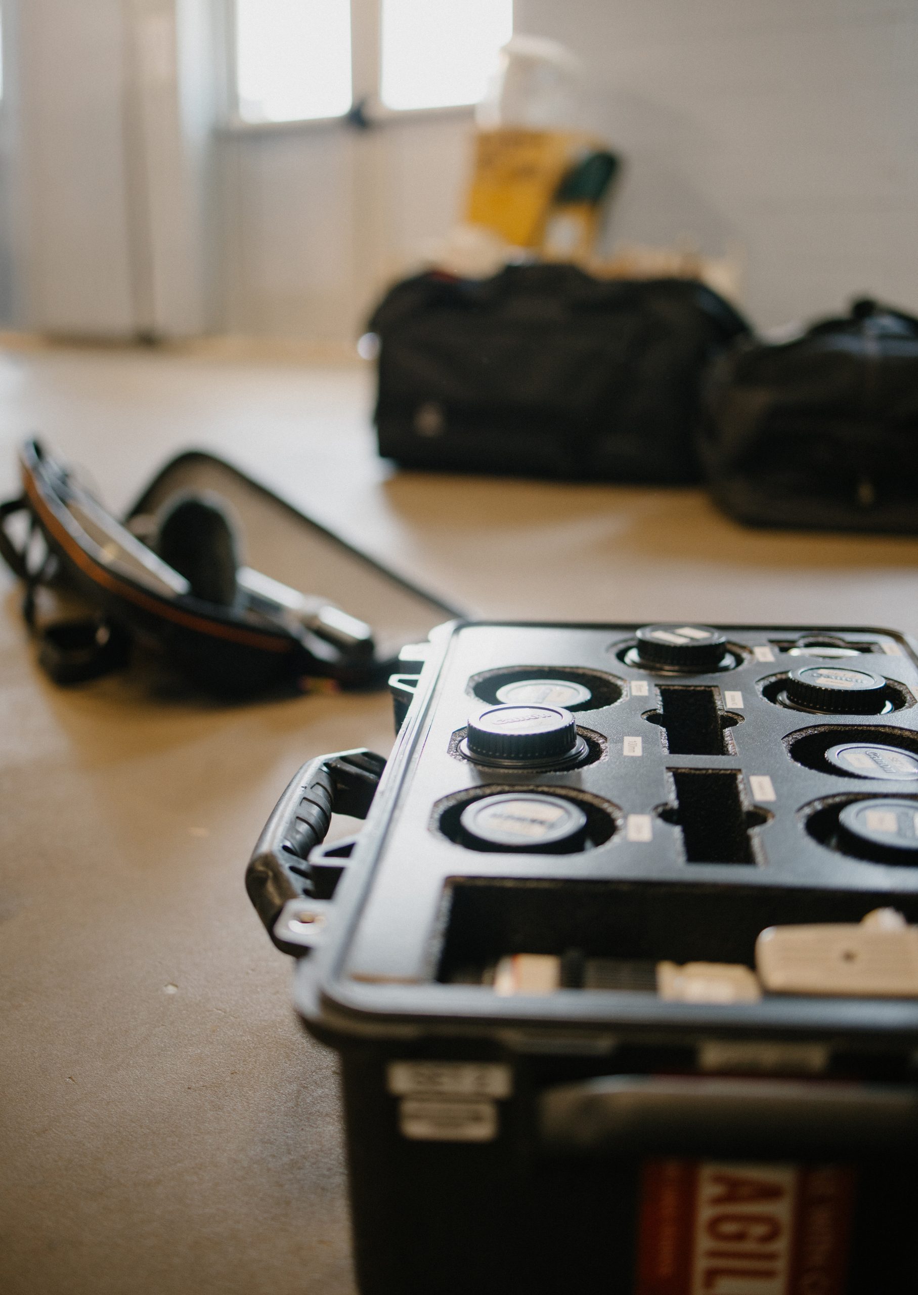 A protective case filled with interchangeable camera lenses and gear laid out for a church shoot, illustrating the best video kit for church media and ministry production.