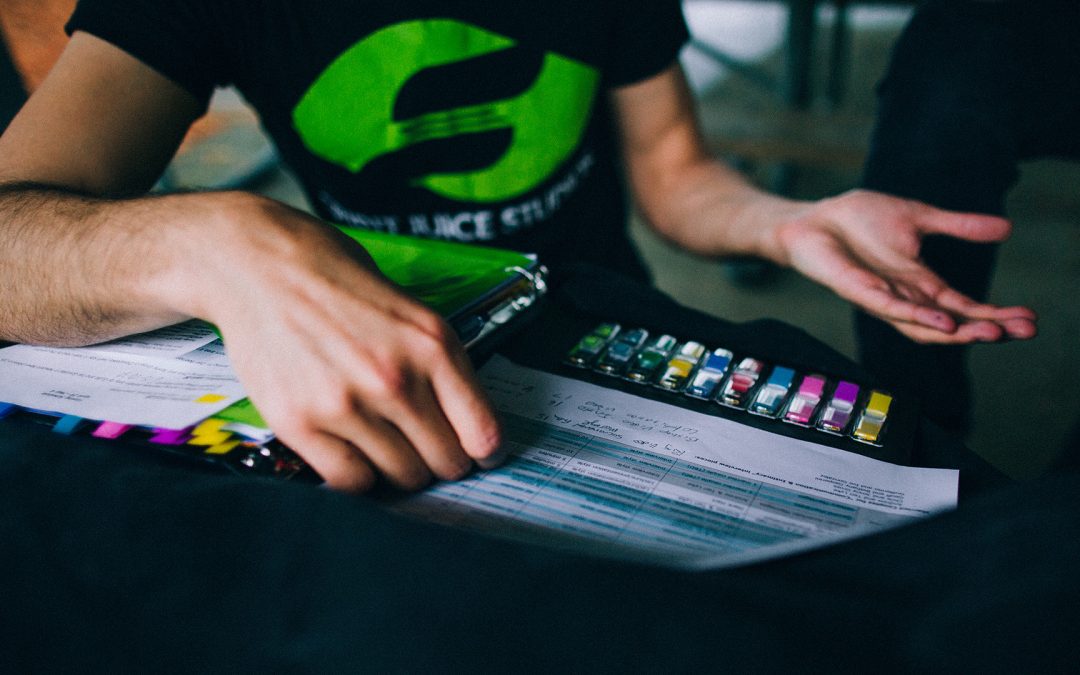A Spirit Juice Studios team member reviews pre-production notes and production budgets, illustrating how video production cost vs value depends on planning, purpose, and creative choices rather than budget alone.