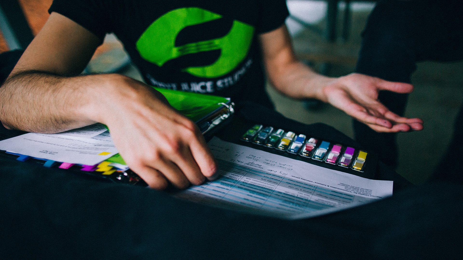 A Spirit Juice Studios team member reviews pre-production notes and production budgets, illustrating how video production cost vs value depends on planning, purpose, and creative choices rather than budget alone.